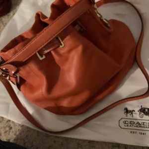 Authentic COACH drawstring small duffle brass/ coral. Inside pocket. Fully lined